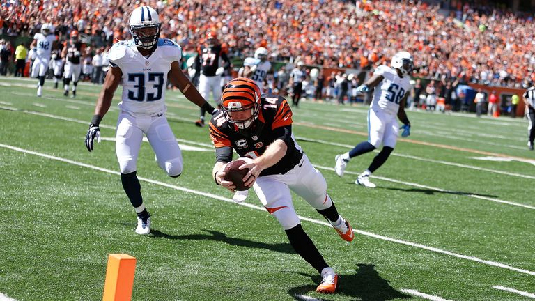 Cincinnati Bengals quarterback Andy Dalton dives into the end zone to score a touchdown against the Tennessee Titans