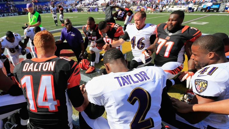 Players form a prayer circle after the Cincinnati Bengals defeated the Baltimore Ravens