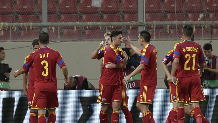 Romania's forward Ciprian Marica (C) celebrates with his teammates after he scored a penalty kick during the qualifying football match for the 2016 Europea