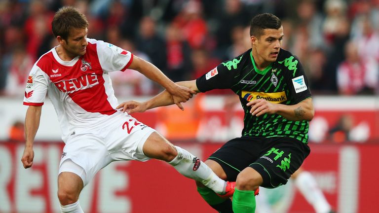 Simon Zoller is challenged by Granit Xhaka