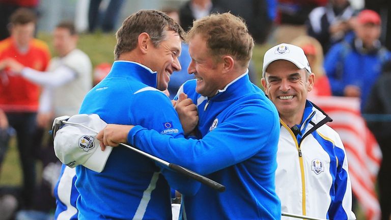 AUCHTERARDER, SCOTLAND - SEPTEMBER 26: Lee Westwood (L) and Jamie Donaldson of Europe celebrate victory watched by Europe team captain Paul McGinley during