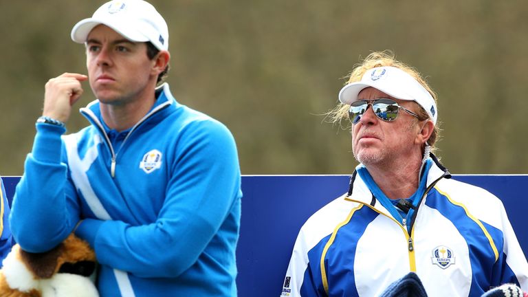 Rory McIlroy ponders his next move as Miguel Angel Jimenez looks on