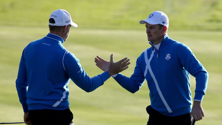 Justin Rose celebrates his birdie with Henrik Stenson on the 4th