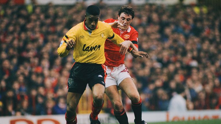 English footballer Brian Deane (left) of Sheffield United  fends off Steve Bruce of Manchester United during an English Premier League match at Old Traffor