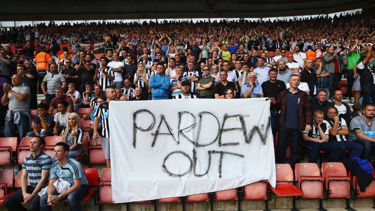   Newcastle United fans hold a 'Pardew Out' banner