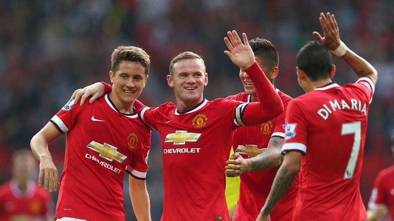 Wayne Rooney of Manchester United celebrates scoring the third goal against QPR