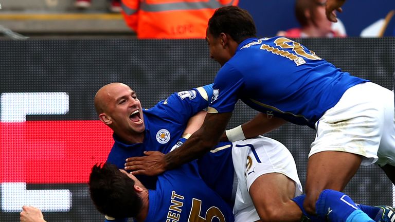 Esteban Cambiasso of Leicester City celebrates with David Nugent and Liam Moore after scoring against Manchester United