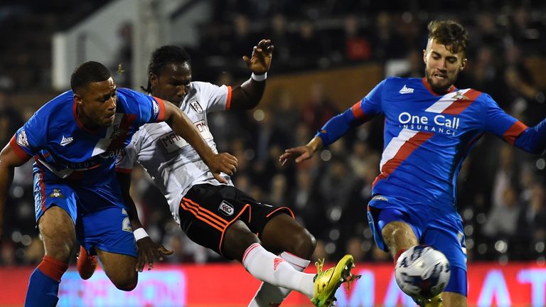 Hugo Rodallega of Fulham shoots wide under pressure from Reece Wabara and Liam Wakefield of Doncaster during the Capital One Cup clash