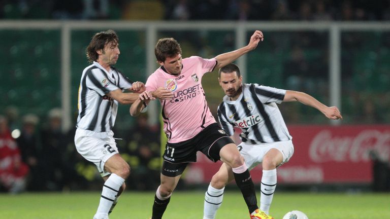 Palermo's forward Franco Vasquez fights for the ball with Juventus's midfielder Andrea Pirlo (L) and Leonardo Bonucci 