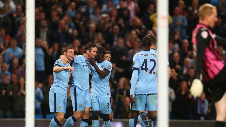 MANCHESTER, ENGLAND - SEPTEMBER 24:  Frank Lampard (2L) of Manchester City celebrates scoring the opening goal with James Milner (L) and Bacary Sagna ((R) 