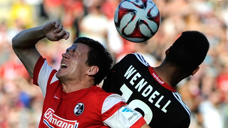 Freiburg's midfielder Sascha Riether (C) vies with Leverkusen's Brazilian defender Wendell (R) vie for the 