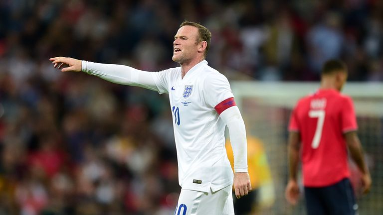 England's Wayne Rooney gestures to team-mates during the International Friendly at Wembley Stadium, London.