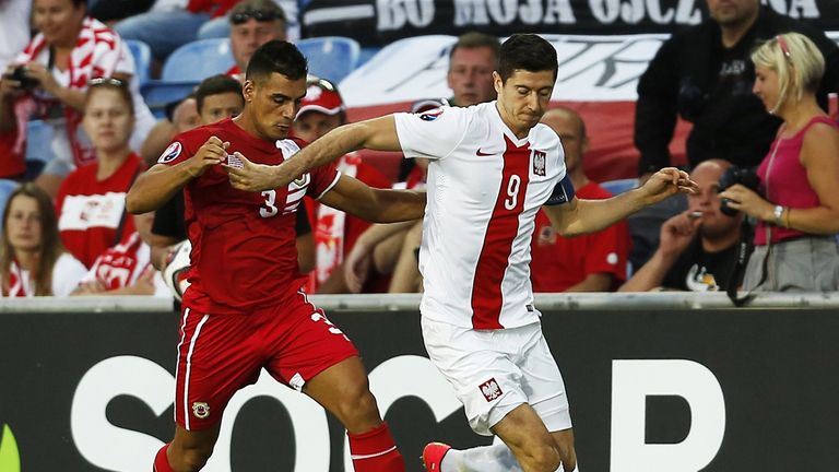 Gibralta's defender Joseph Chipolina (L) vies with Poland's forward Robert Lewandowski during the UEFA Euro 2016 group D qualifying football match Gibralta