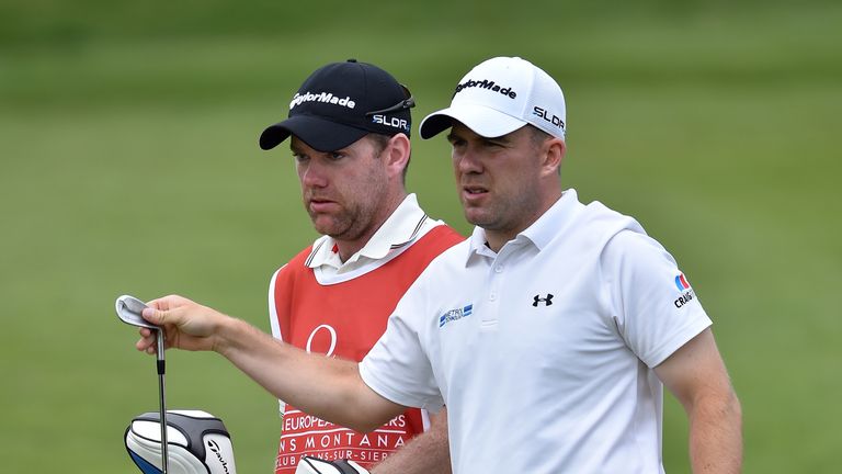 Richie Ramsay and caddie ponder a shot during the first round of the Omega European Masters