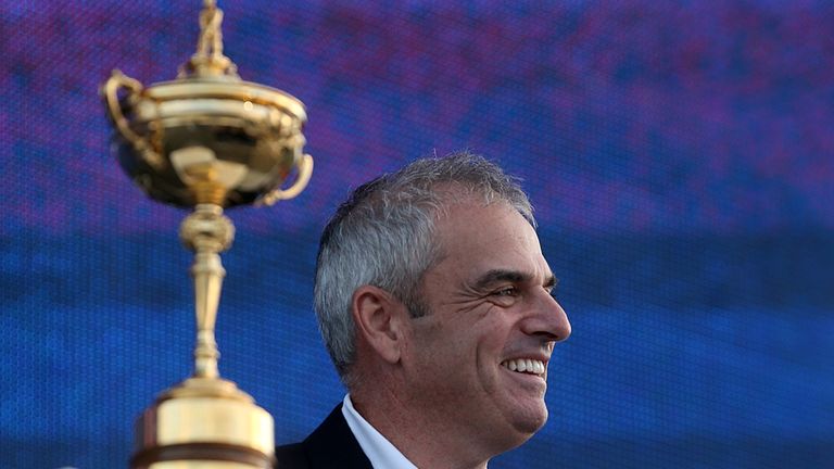 Paul McGinley is later presented with the trophy