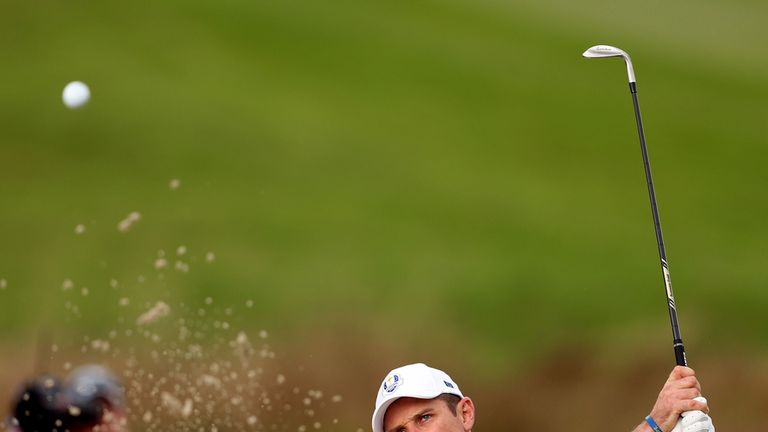 Justin Rose plays out a bunker early on day three