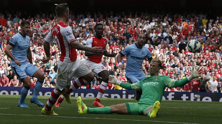 Arsenal's English midfielder Jack Wilshere (2-R) scores an equalising goal past Manchester City's English goalkeeper Joe Hart (R) bringing the score to 1-1