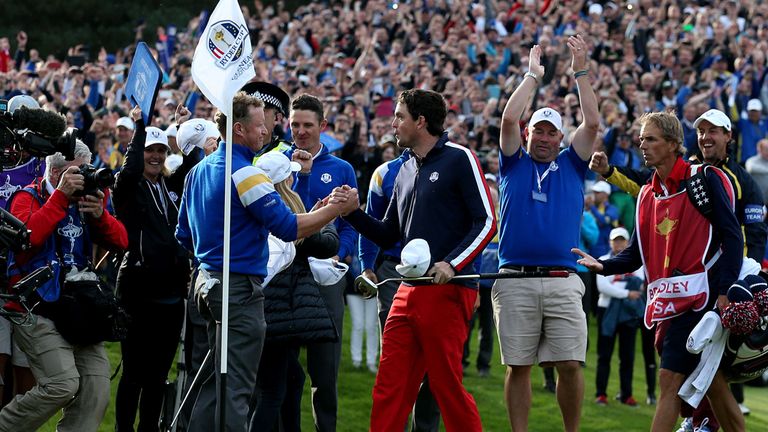 Jamie Donaldson shakes hands with Keegan Bradley after winning his singles match which ensures Europe would earn at least 14.5 points