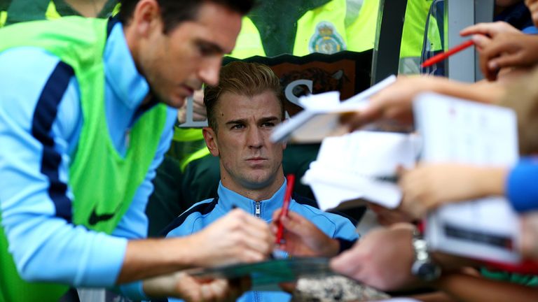 Joe Hart of Manchester City looks on from the bench 