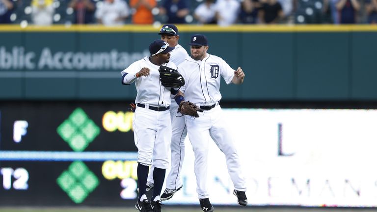 Rajai Davis, Ezequiel Carrera and Tyler Collins  of the Detroit Tigers celebrate after the final out of the game against Kansas City Royals 