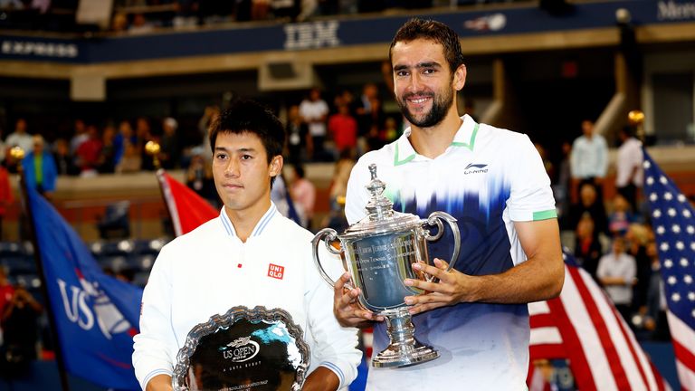 Kei Nishikori and Marin Cilic of Croatia pose with trophies at the US Open