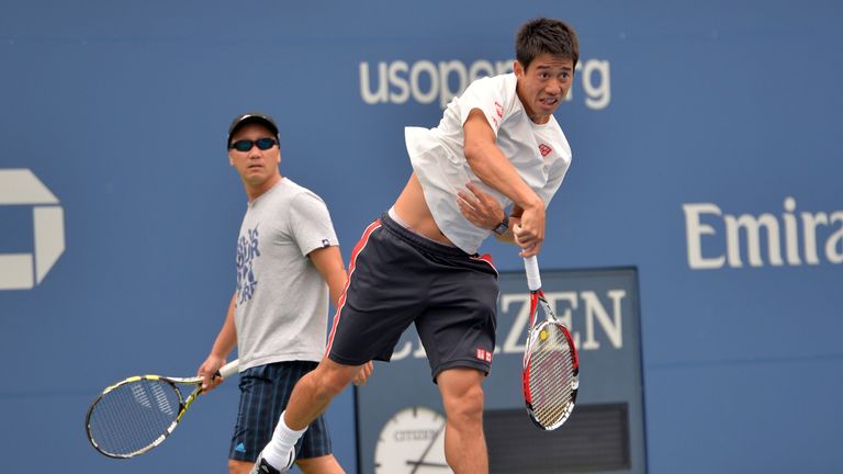 Coach Michael Chang (L) looks on as Kei Nishikori of Japan practises at the US Open