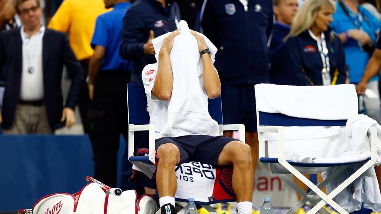 Kei Nishikori wipes his face while playing in the US Open final