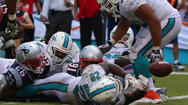 Miami Dolphins' Knowshon Moreno loses the ball after scoring a fourth-quarter touchdown against the New England Patriots