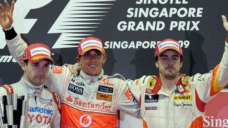 Lewis Hamilton celebrates with fellow podium finishers Timo Glock and Fernando Alonso after winning the 2009 Singapore GP
