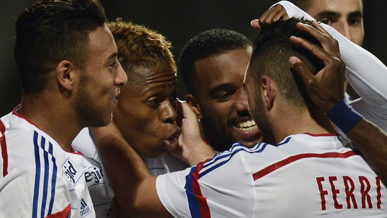 Lyon's Cameroonian midfielder Clinton Mua Njie (2nd L) celebrates with team mates after he scored a goal during 