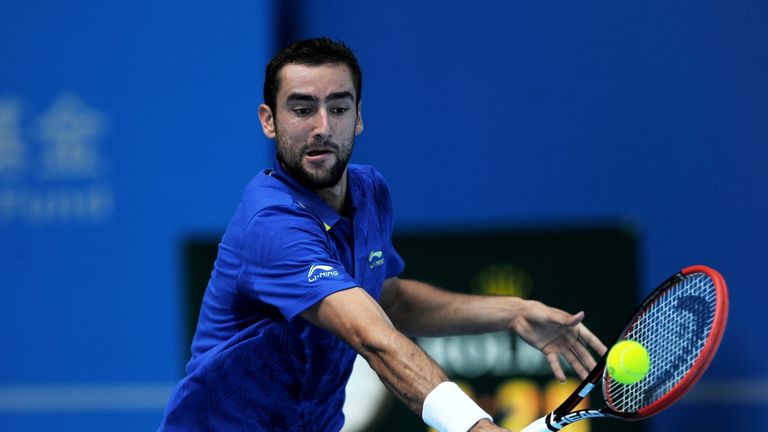 Marin Cilic returns to Yan Bai during their men's singles first round match at the China Open