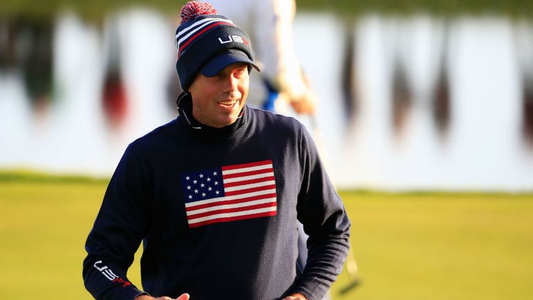 Matt Kuchar, with bobble hat and cap, is annoyed with himself after missing a putt