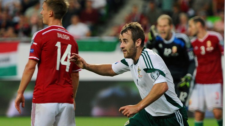 Northern Ireland's midfielder Niall McGinn (R) celebrates after scoring during the UEFA Euro 2016 Group F qualifying match of Hungary vs Northern Ireland o