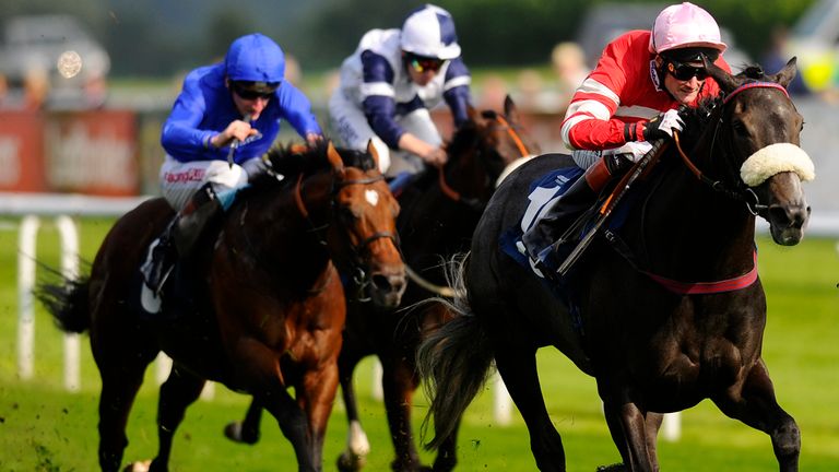 DONCASTER, ENGLAND - SEPTEMBER 10: Paul Mulrennan riding Mecca's Angel win The John Smith's Original Scarbrough Stakes at Doncaster racecourse.