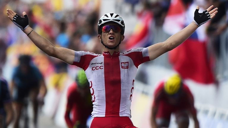 Michal Kwiatkowski celebrates as he crosses the finish line to win the men's road race at the 2014 UCI Road World Championships in Ponferrada 