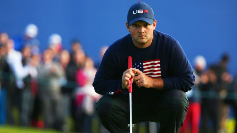 Patrick Reed lines up a putt as the USA and Europe jostle for a stranglehold