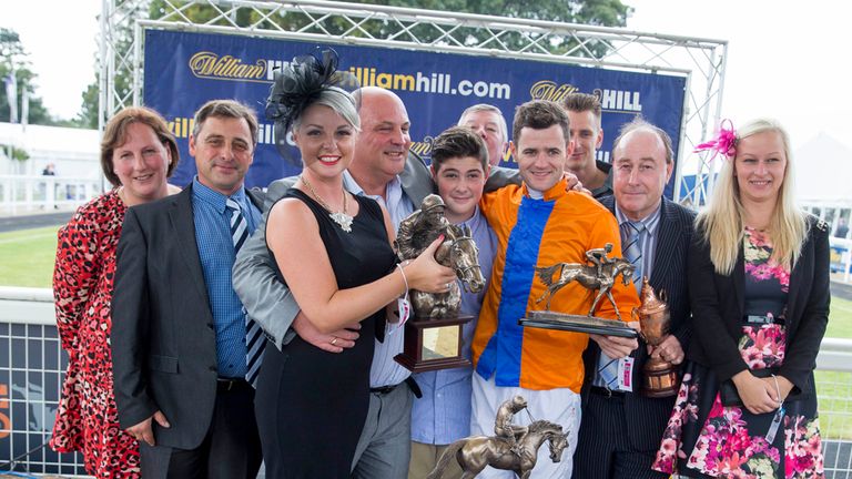 Jockey David Nolan with connections celebrates after Expose won the William Hill Ayr Bronze Cup Handicap Stakes during day two of the 2014 William Hill Ayr