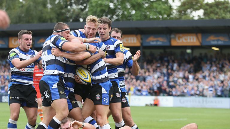 Peter Stringer of Bath is mobbed by team mates after scoring a try during the Aviva Premiership match between Bath and Leicester