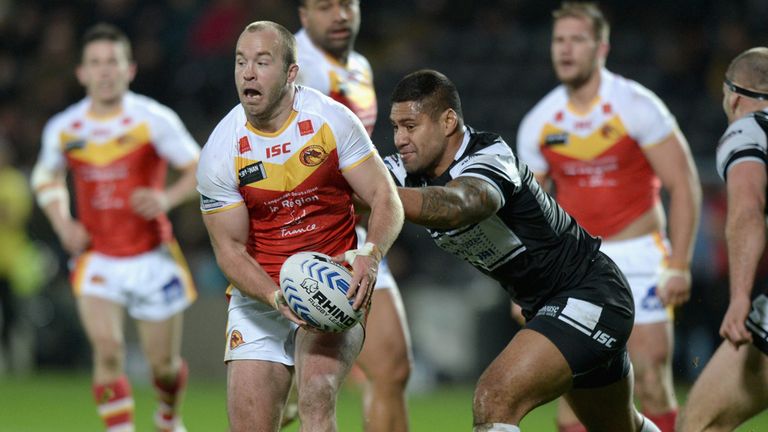 HULL, ENGLAND - FEBRUARY 14:  Ian Henderson of Catalan Dragons gets past Mickey Paea of Hull FC during the Super League match.