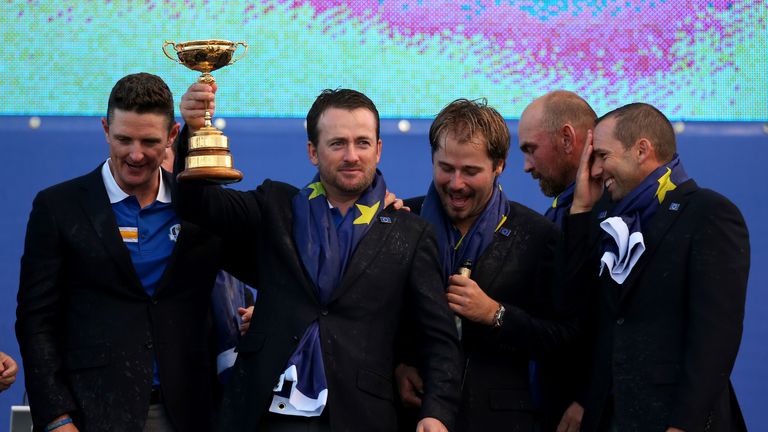 Graeme McDowell holds the Ryder Cup trophy aloft