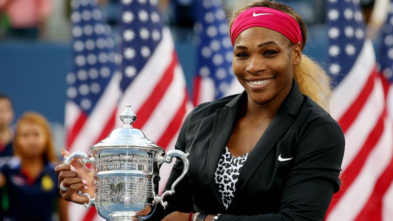 Serena Williams celebrates with the trophy after defeating Caroline Wozniacki at the 2014 US Open final