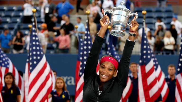 Serena Williams celebrates with the 2014 US Open trophy after defeating Caroline Wozniacki