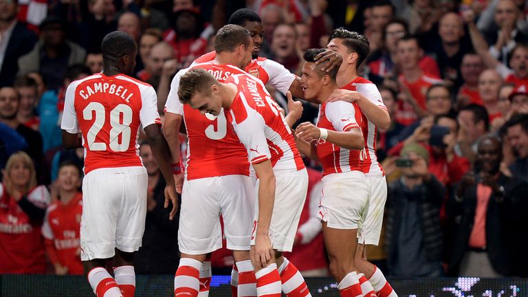 Arsenal's Alexis Sanchez celebrates with his team mates after he scores their side's first goal of the game during the Capital One Cup Third Round match