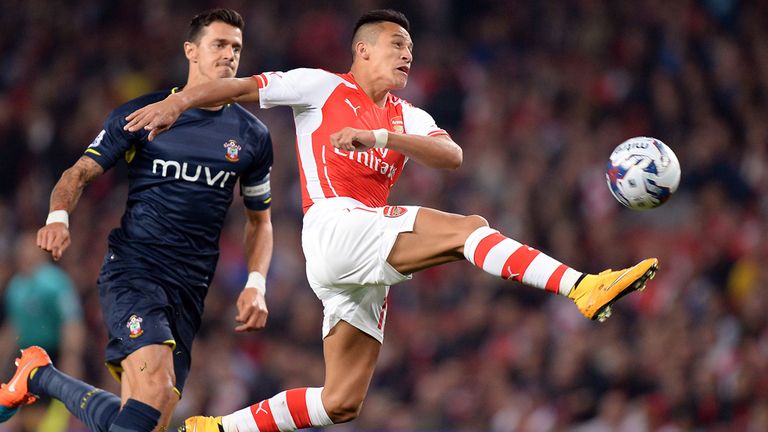 Arsenal's Alexis Sanchez (right) stretches for the ball as he gets past Southampton's Jose Fonte during the Capital One Cup Third Round match