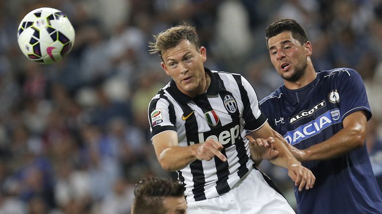 Juventus' defender Stephan Lichtsteiner (L) fights for the ball with Udinese's defender Allan Marques during the Italian Serie A football match Juventus vs