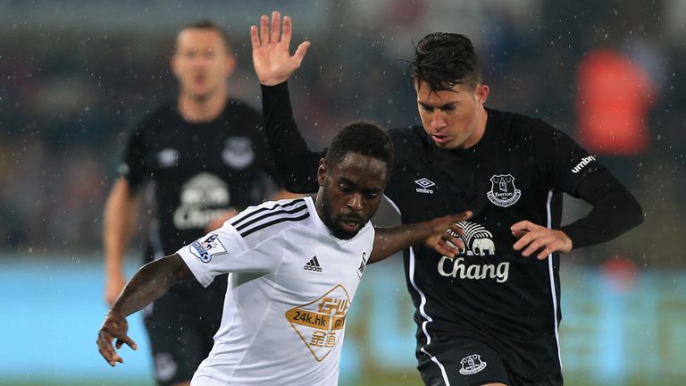 Swansea City's Nathan Dyer battles for the ball with Everton's Bryan Oviedo during the Capital One Cup Third Round match at the Liberty Stadium, Swansea.