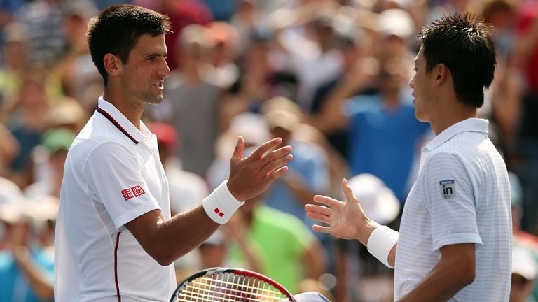 Kei Nishikori of Japan greats Novak Djokovic (L) of Serbia after their men's singles semifinal match at the US Open