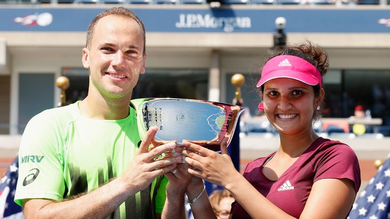 Sania Mirza (R) of India and Bruno Soares (L) of Brazil celebrate with the mixed doubles trophy at the US Open