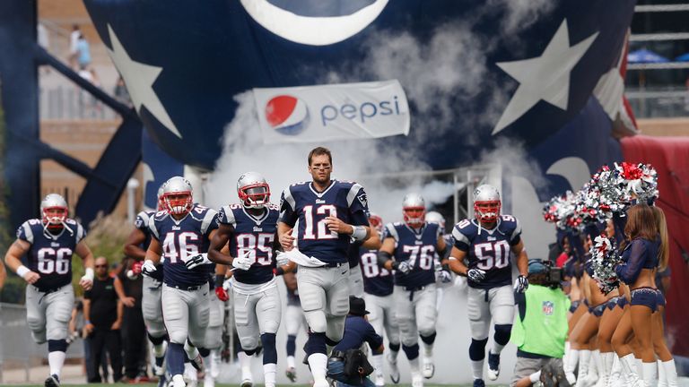 Tom Brady leads the New England Patriots onto the field before a game against the Oakland Raiders