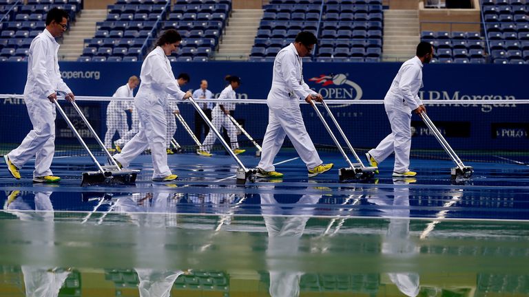 US Open 2014. Groundstaff prepare the court after a rain delay at Flushing Meadows.